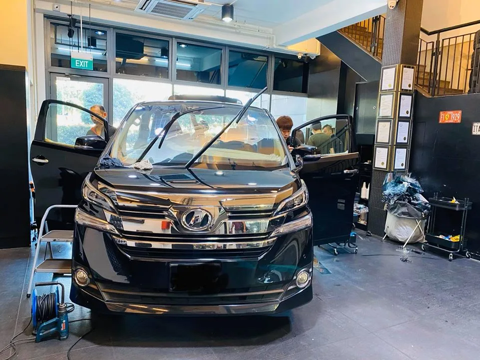 Black Toyota Vellfire MPV being prepped for window tinting at Infratint Singapore