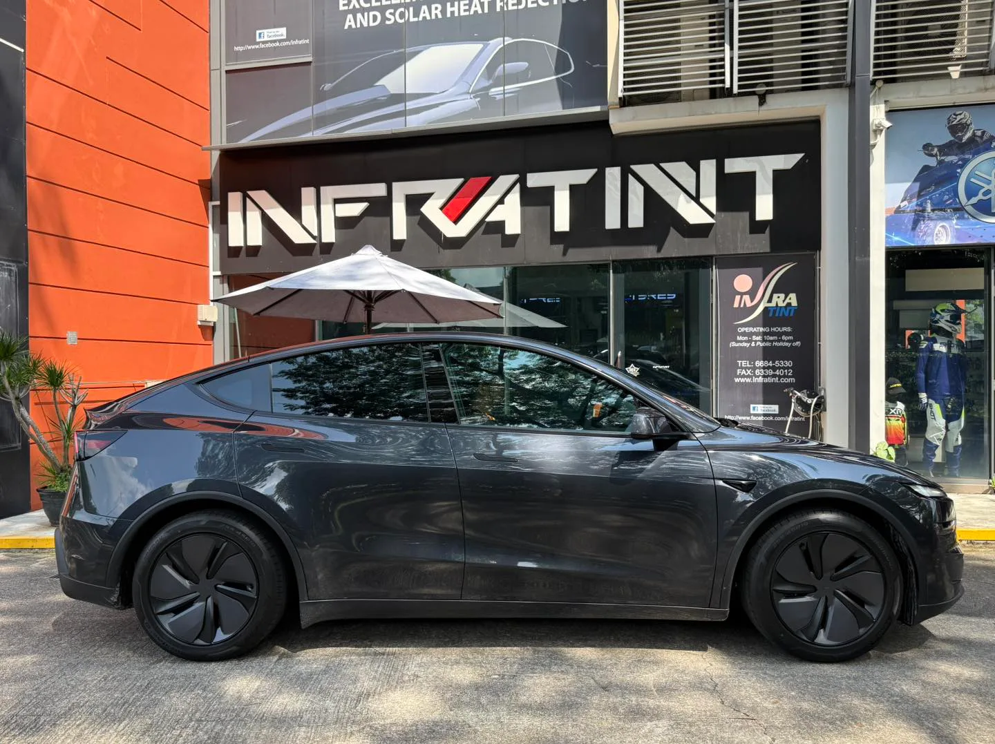 Tesla Model Y Juniper side profile with tinted windows outside Infratint Singapore