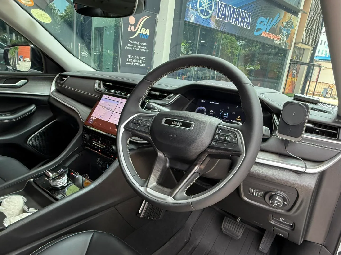 Jeep Cherokee dashboard and steering wheel seen through tinted glass at Infratint Singapore