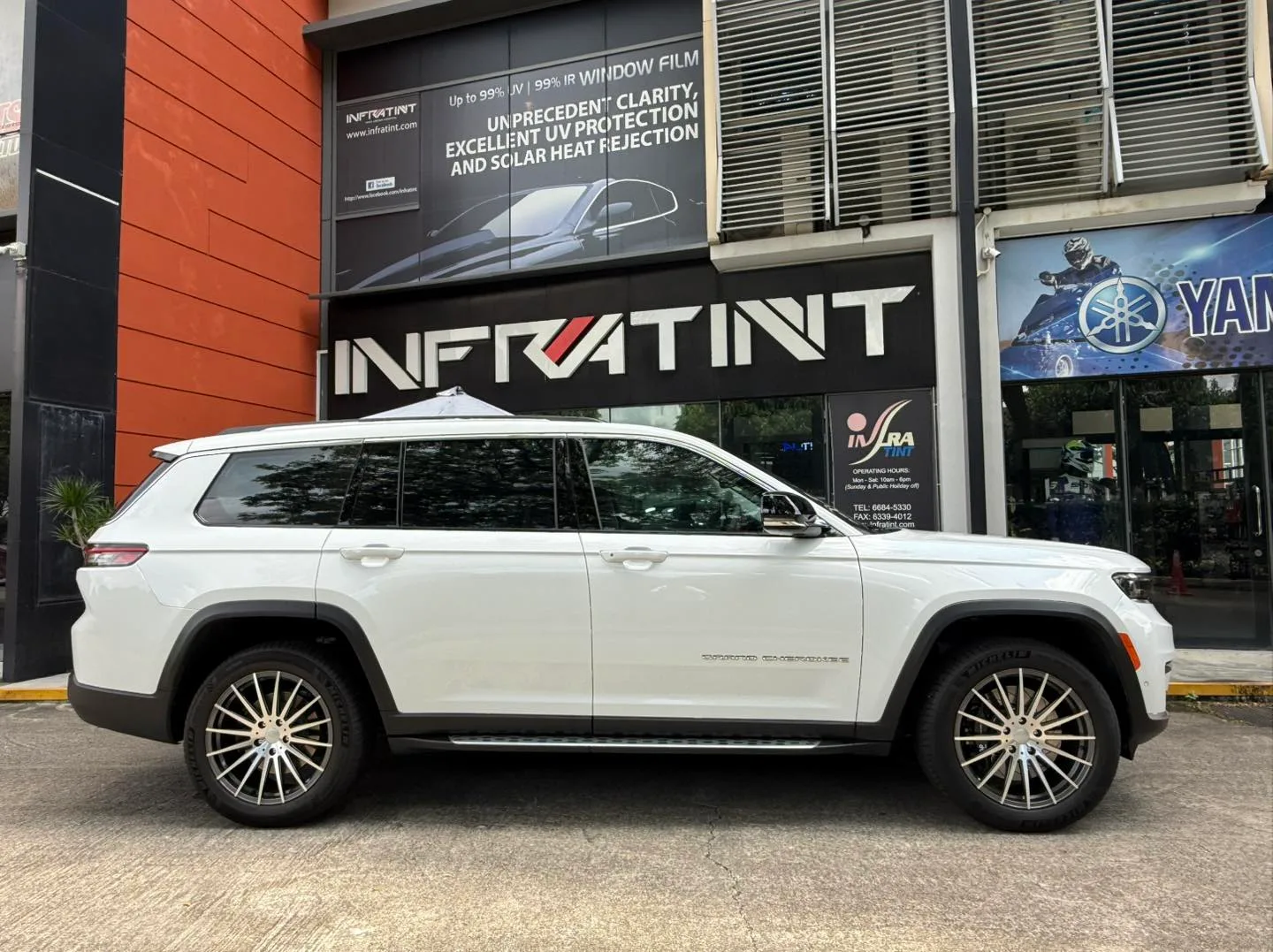 Tinted white Jeep Cherokee side profile outside Infratint Singapore