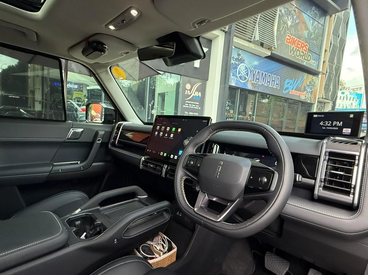 Jaecoo J6 dashboard and steering wheel seen through tinted glass at Infratint Singapore