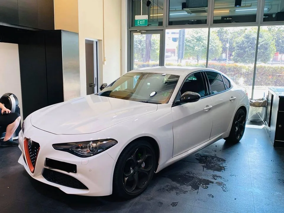 White Alfa Romeo Giulia with tinted windows inside Infratint Singapore showroom