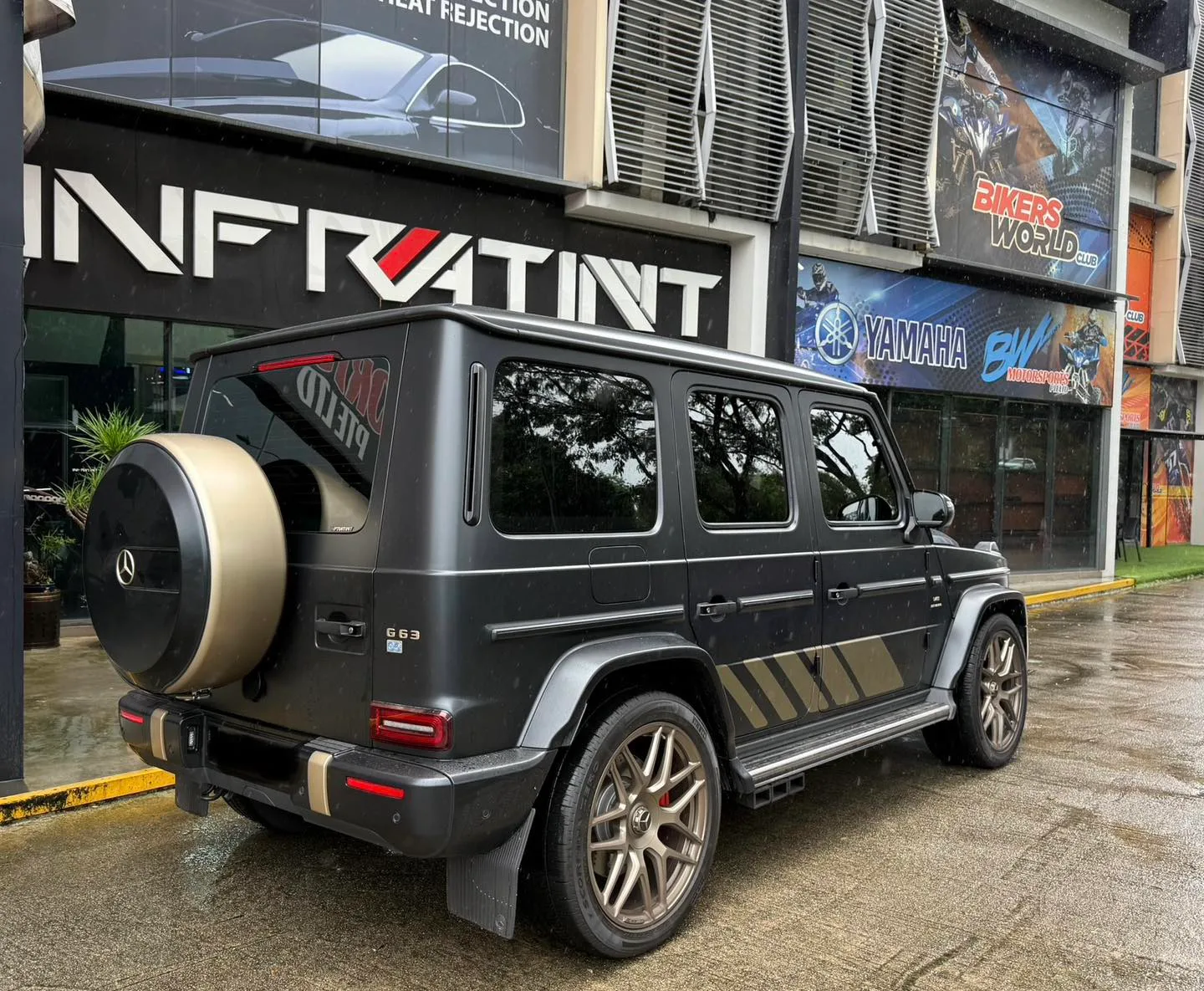 Matte grey Mercedes-Benz G-Wagon rear three-quarter view with spare wheel outside Infratint Singapore