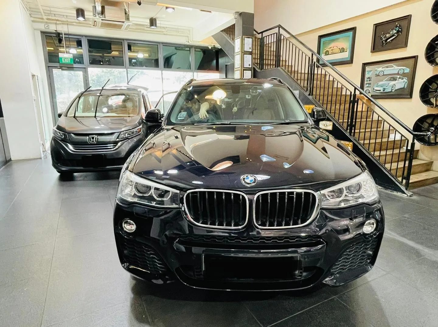 Black BMW X3 getting window tinting at the Infratint Singapore showroom
