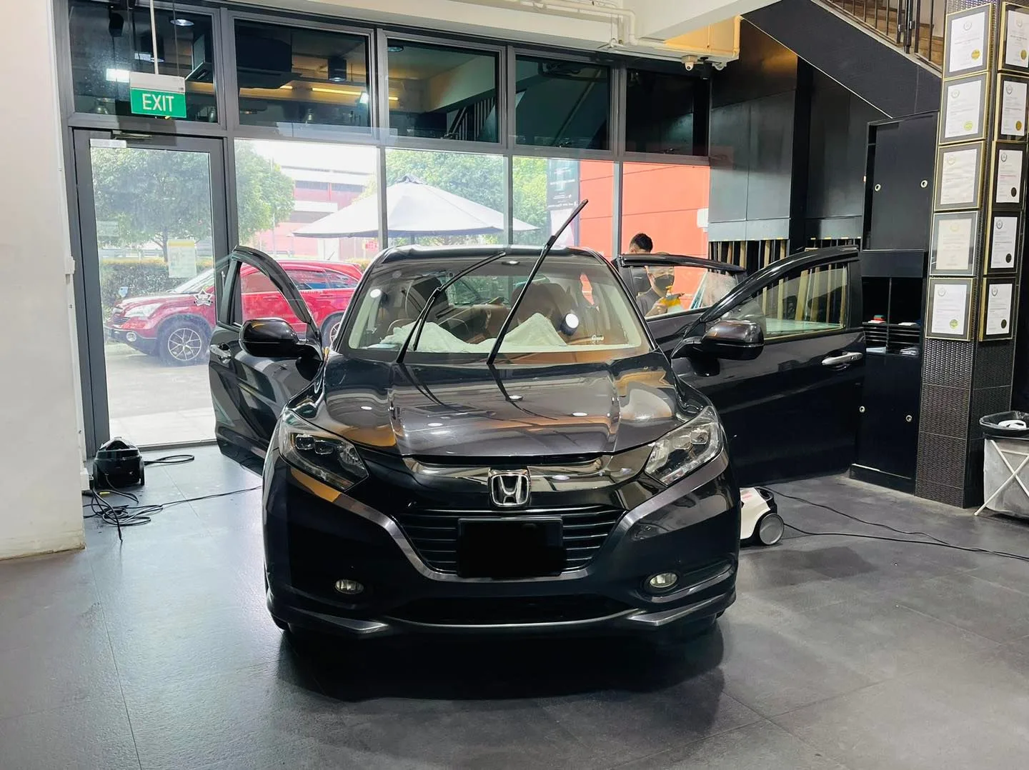 Black Honda crossover being prepared for window tinting at Infratint Singapore