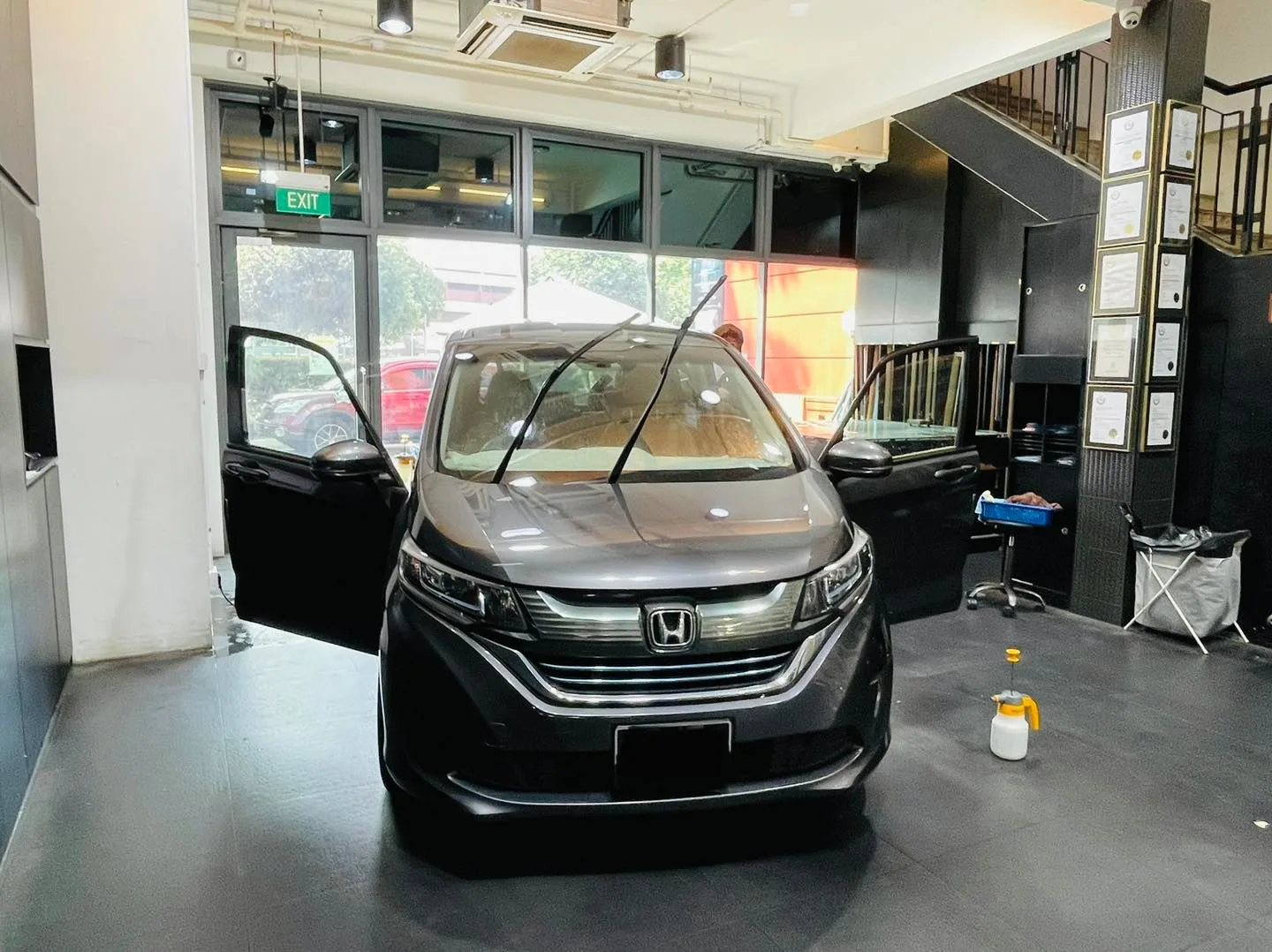 Grey Honda people-mover awaiting window tinting at Infratint Singapore