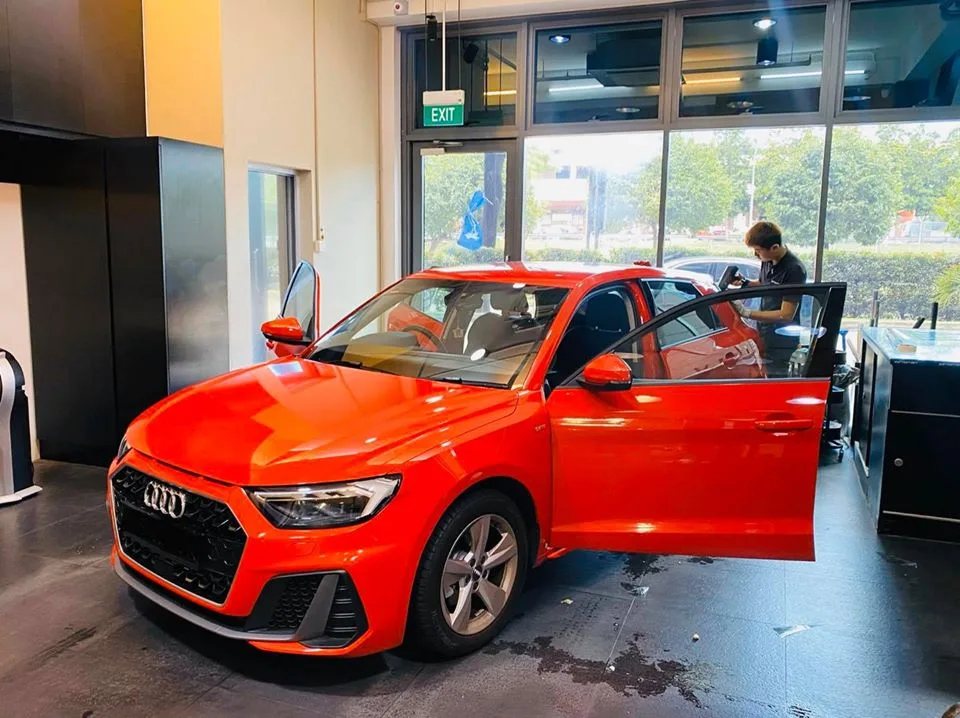 Bright red Audi A1 front three-quarter during a tint install at Infratint Singapore