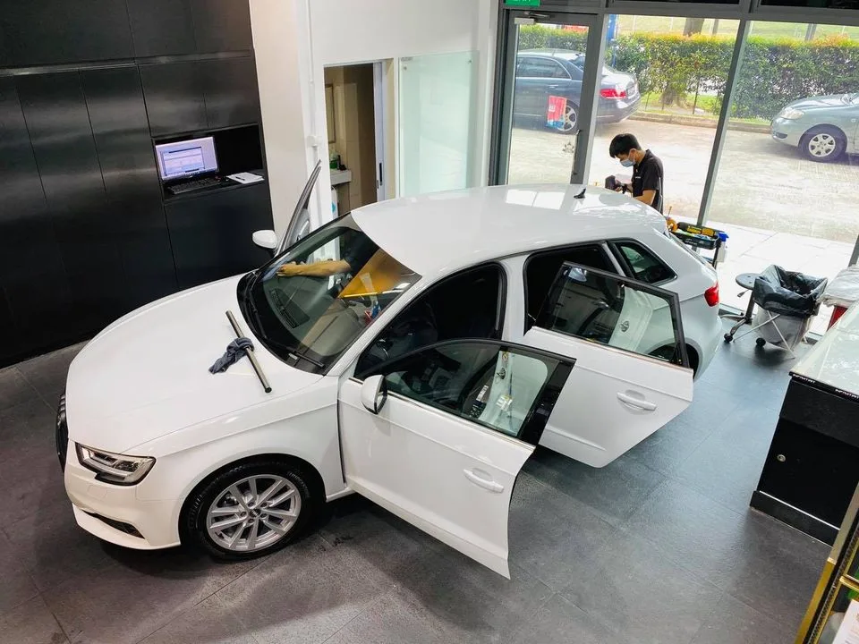 Overhead view of a white Audi A3 being tinted at Infratint Singapore