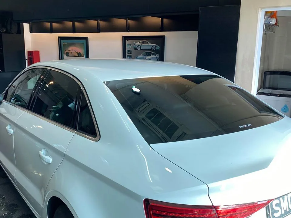 Tinted rear windows on a white Audi sedan at Infratint Singapore