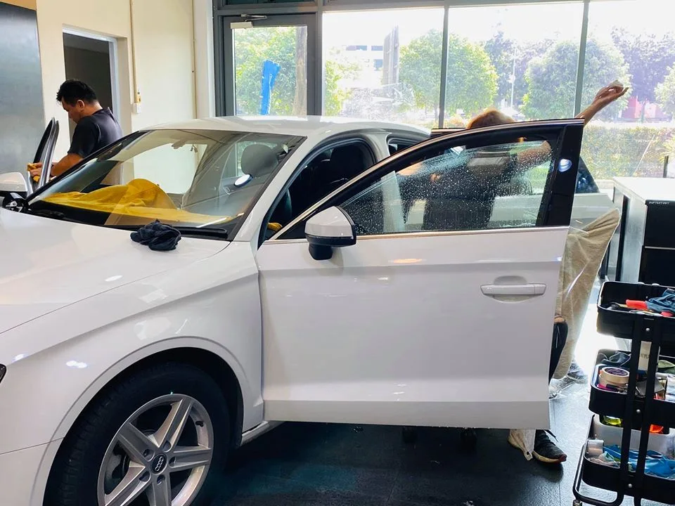 White Audi sedan having its windows tinted with doors open at Infratint Singapore