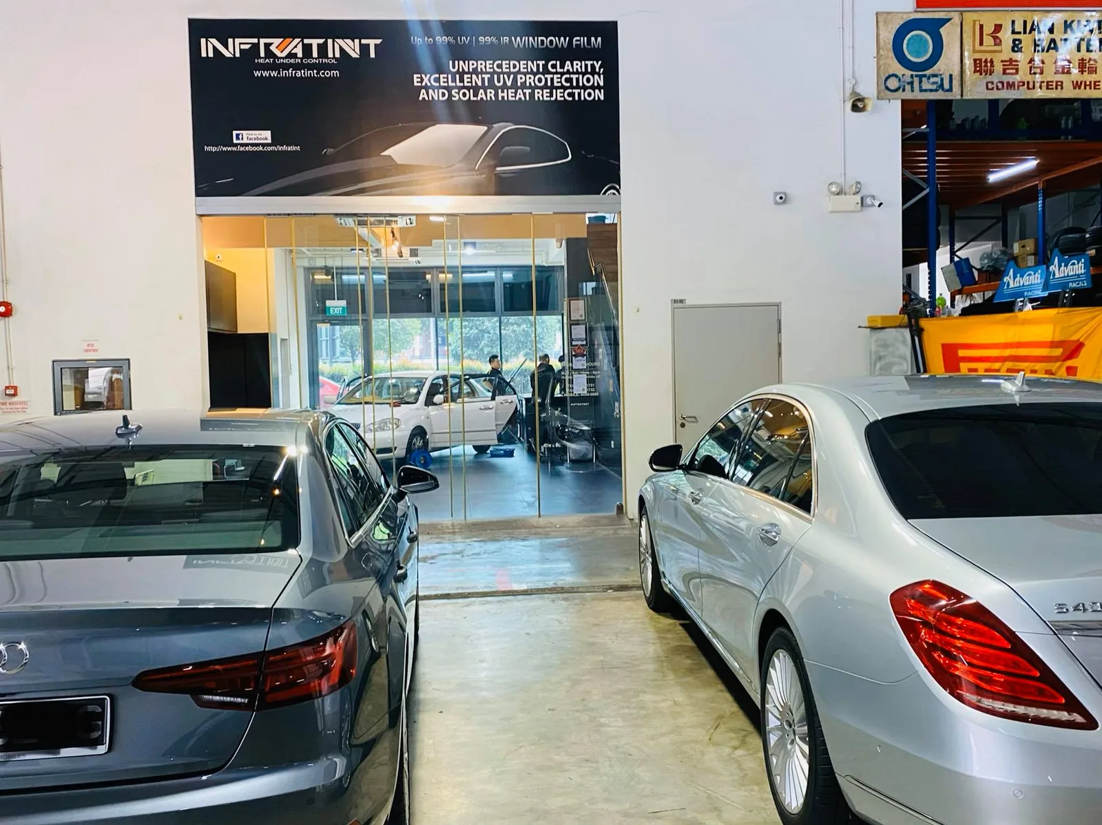 Grey Audi sedan and silver Mercedes-Benz S-Class inside Infratint Singapore