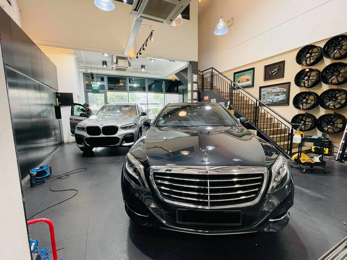 Black Mercedes-Benz S-Class and a BMW inside Infratint Singapore showroom