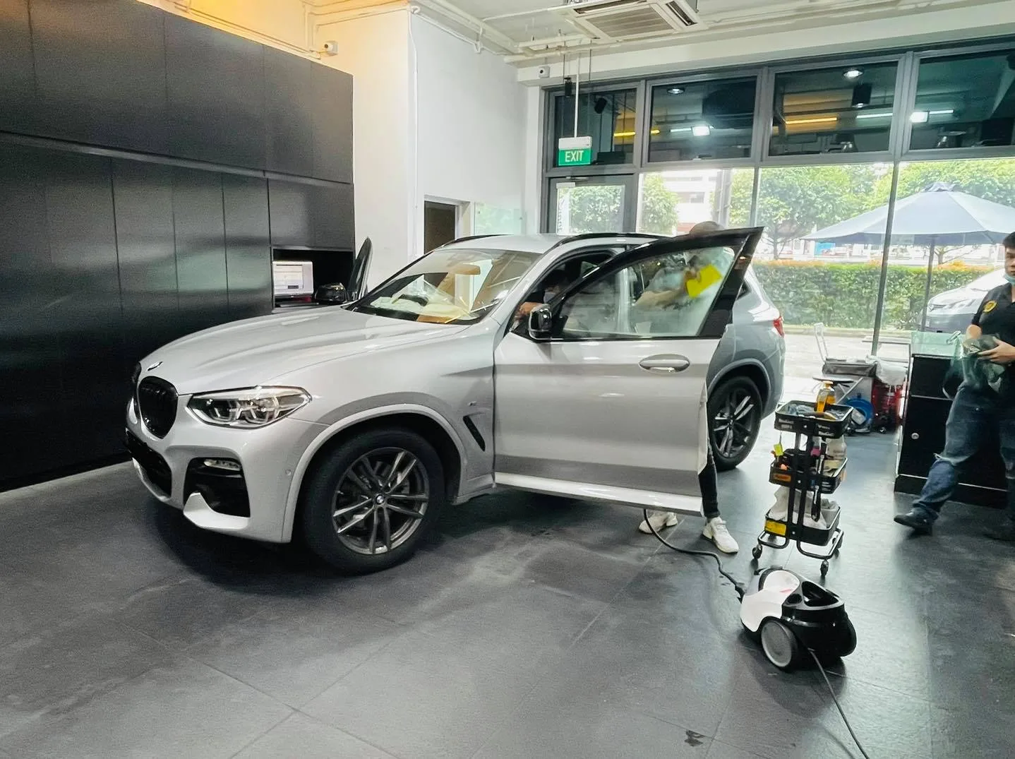 Silver BMW SUV front three-quarter during window tinting at Infratint Singapore