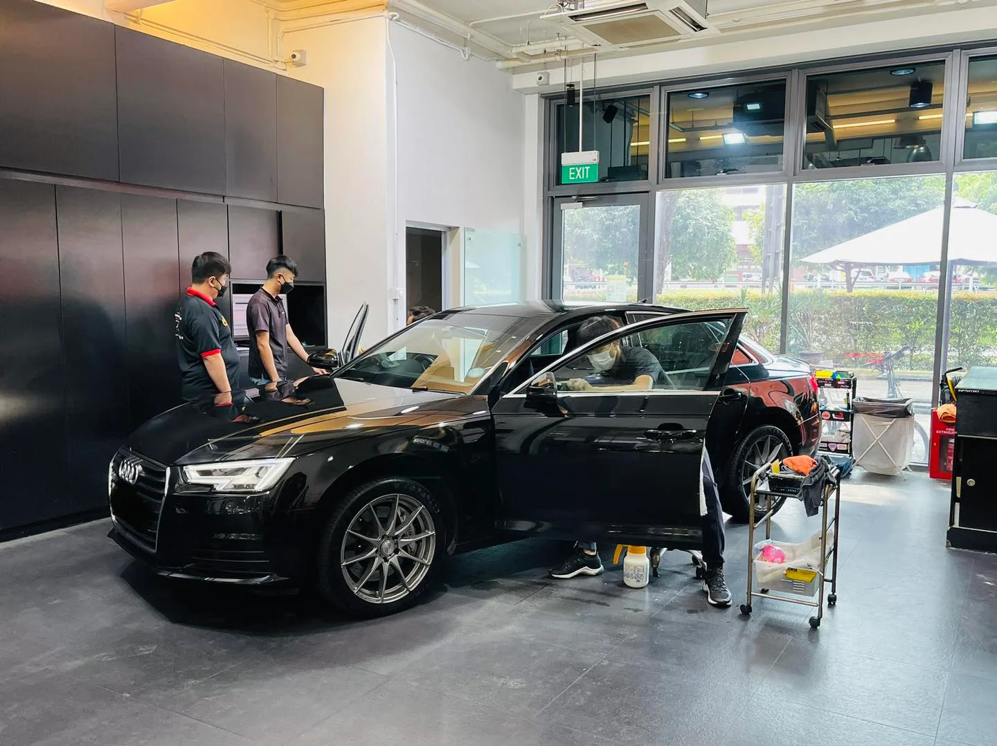 Black Audi A4 side view during window tinting at Infratint Singapore