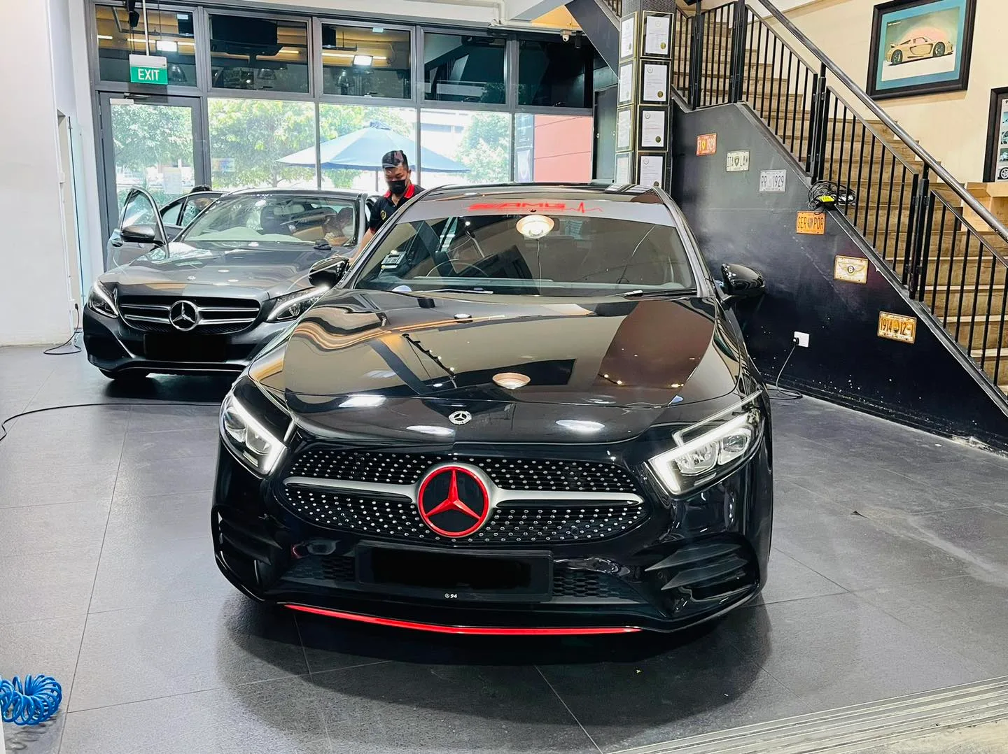Black Mercedes-Benz A-Class and grey C-Class inside the Infratint Singapore showroom