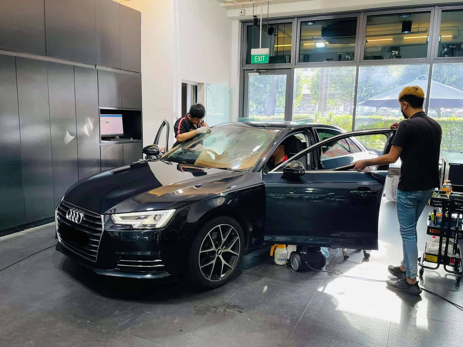 Black Audi A4 getting side window film fitted at Infratint Singapore