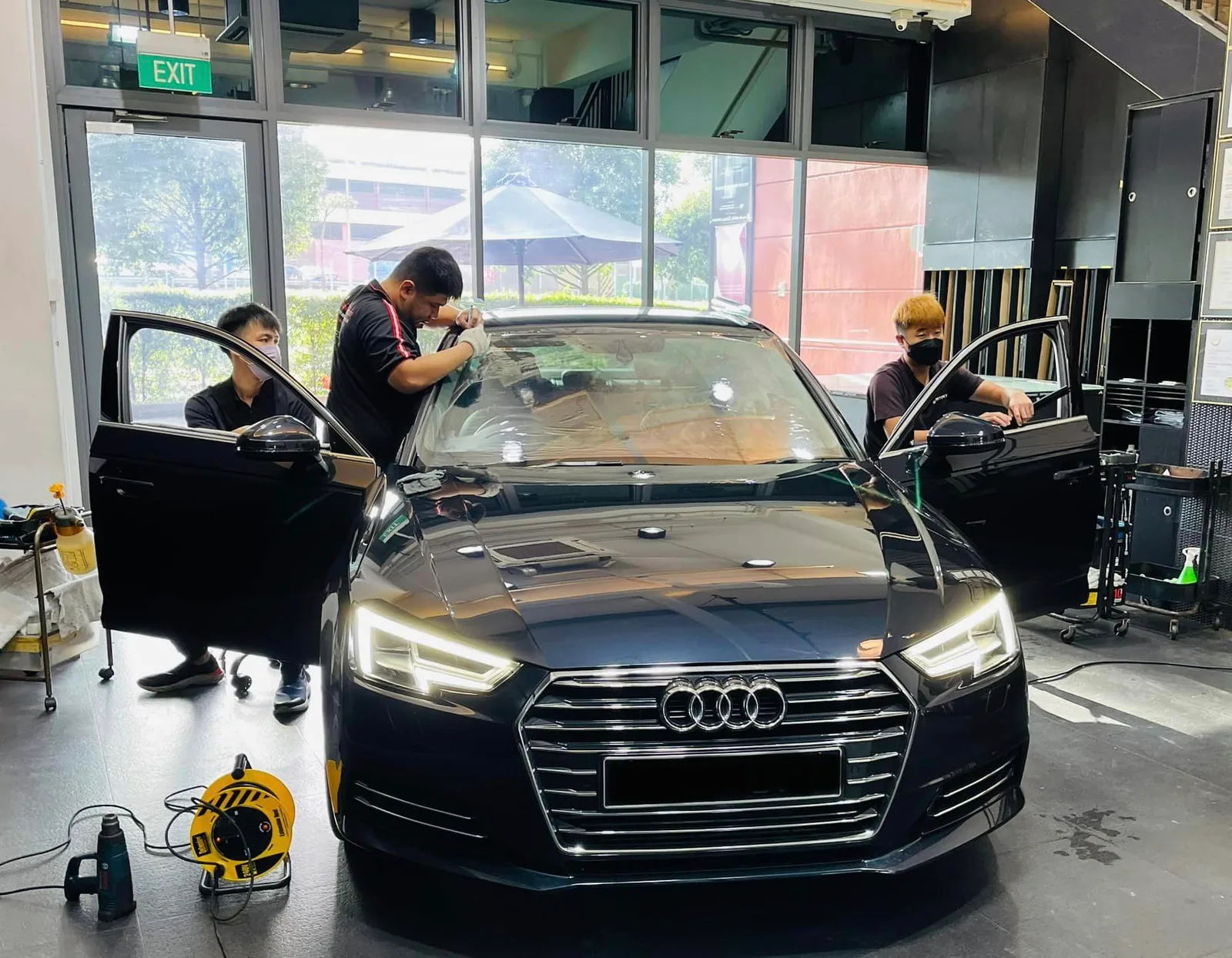 Black Audi sedan having its windscreen tinted at Infratint Singapore
