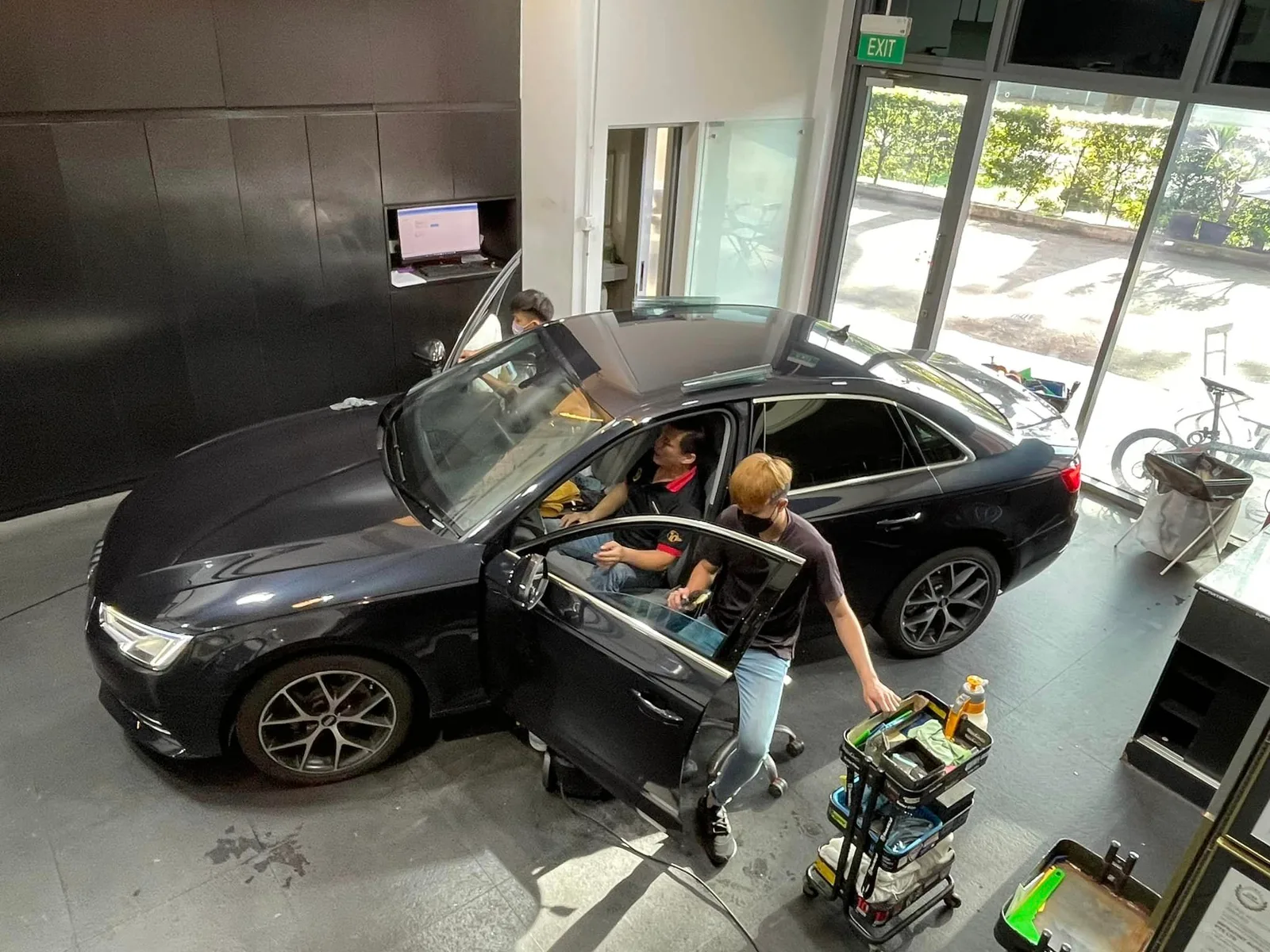 Overhead view of a black Audi sedan being tinted at Infratint Singapore