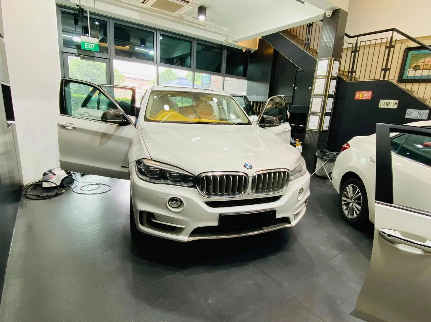 White BMW X5 with doors open at Infratint Singapore for window film installation