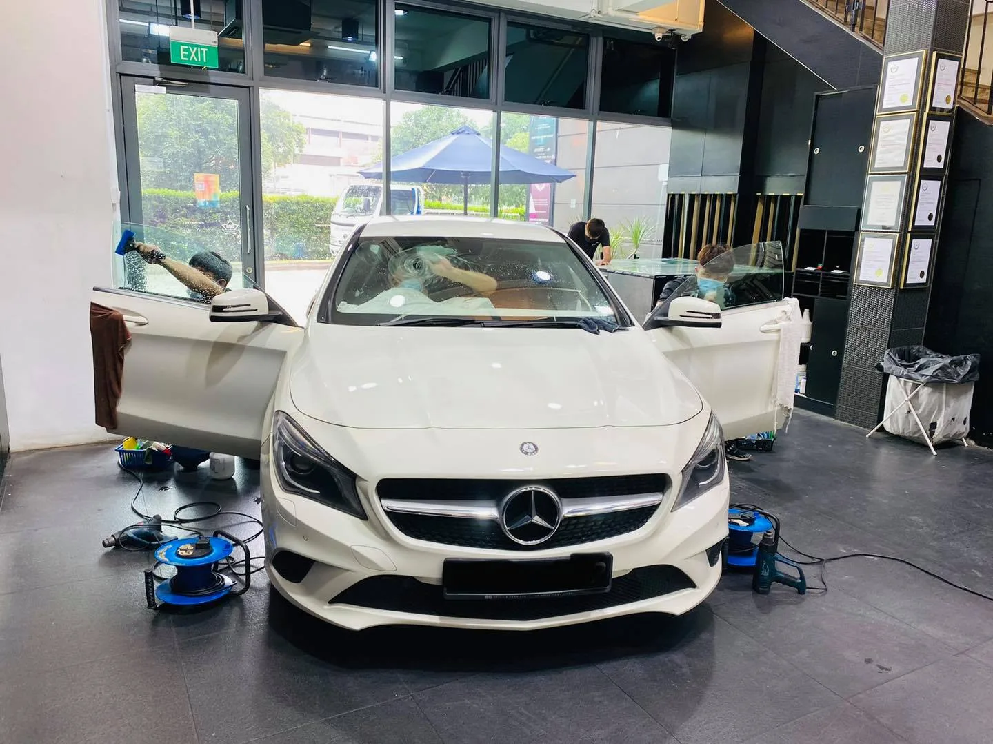 White Mercedes-Benz CLA being prepared for window tinting at Infratint Singapore