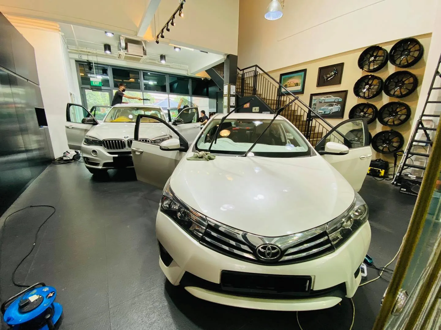 White Toyota Altis inside the Infratint Singapore showroom for window tinting