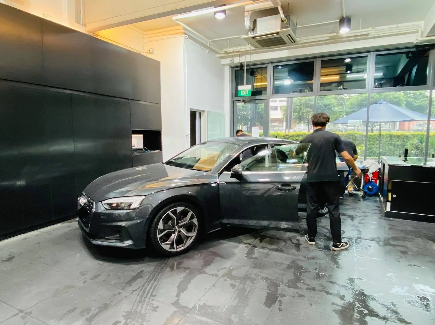 Dark grey Audi sportback side view during window tinting at Infratint Singapore