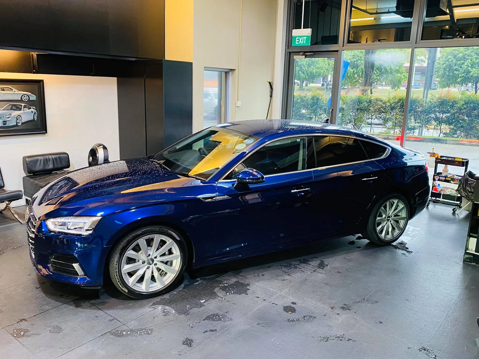 Side profile of a deep blue Audi Sportback with tinted windows at Infratint Singapore