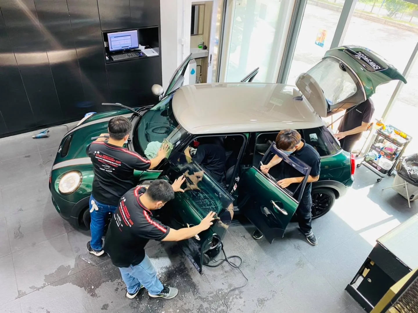 Overhead view of a green Mini Cooper S being tinted at Infratint Singapore