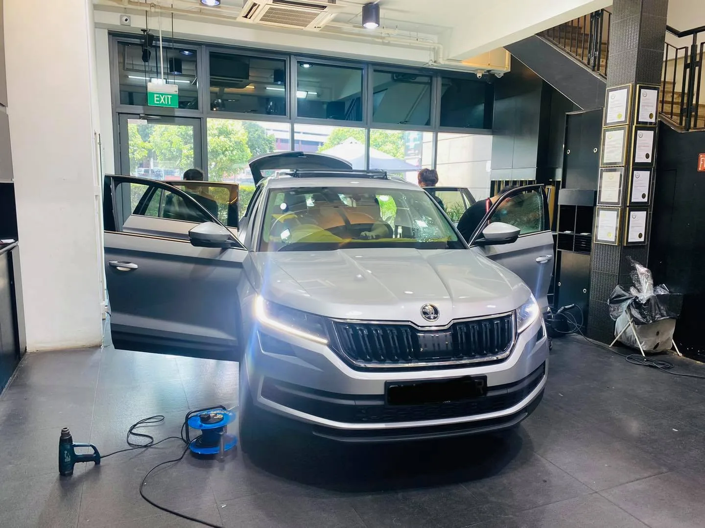Silver Skoda Kodiaq with doors open during window tinting at Infratint Singapore