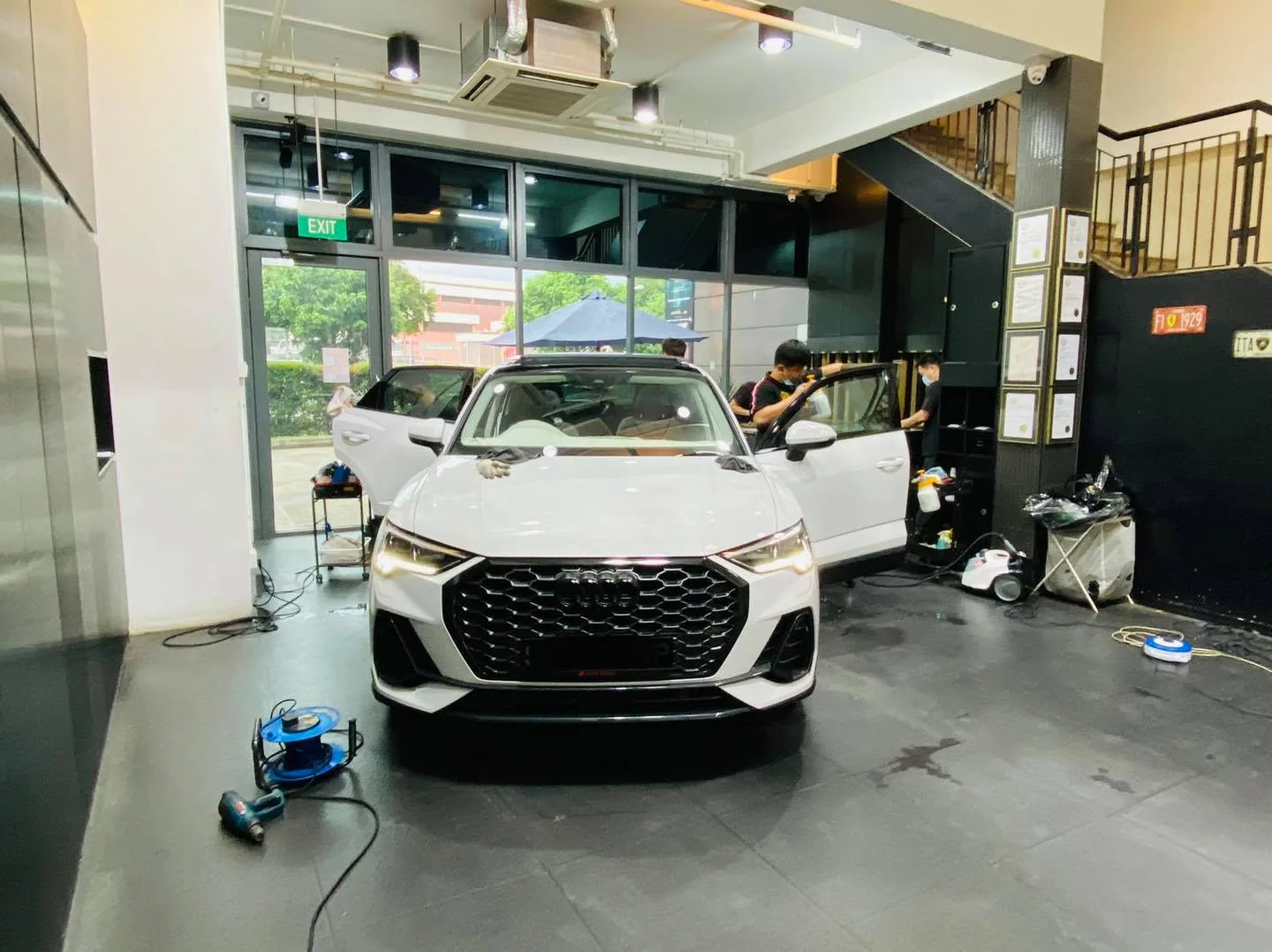 White Audi Q3 with doors open during window tinting at Infratint Singapore