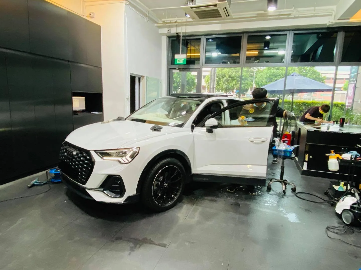 White Audi Q3 front three-quarter during window film install at Infratint Singapore