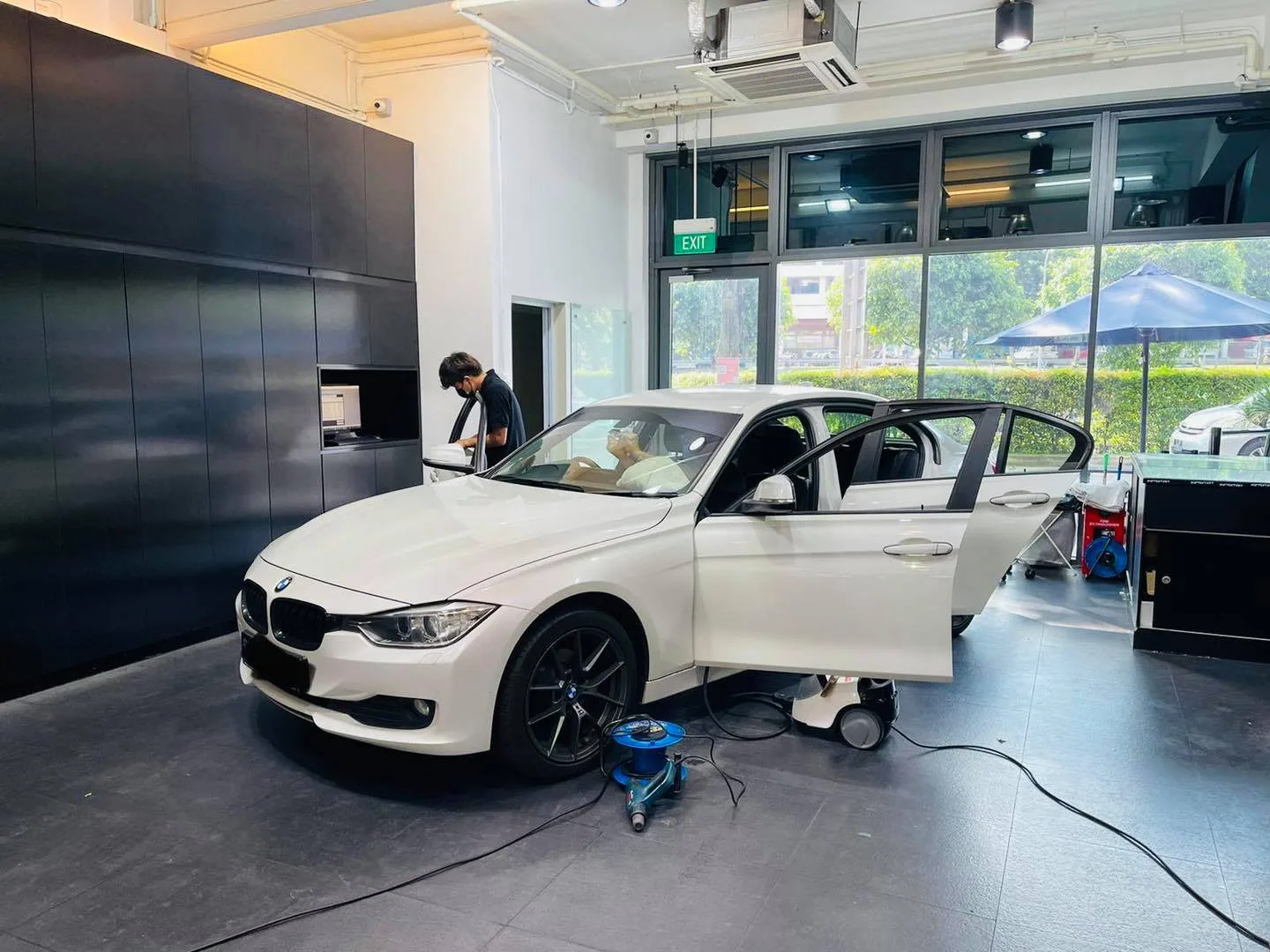 White BMW 3 Series side view during window tinting at Infratint Singapore