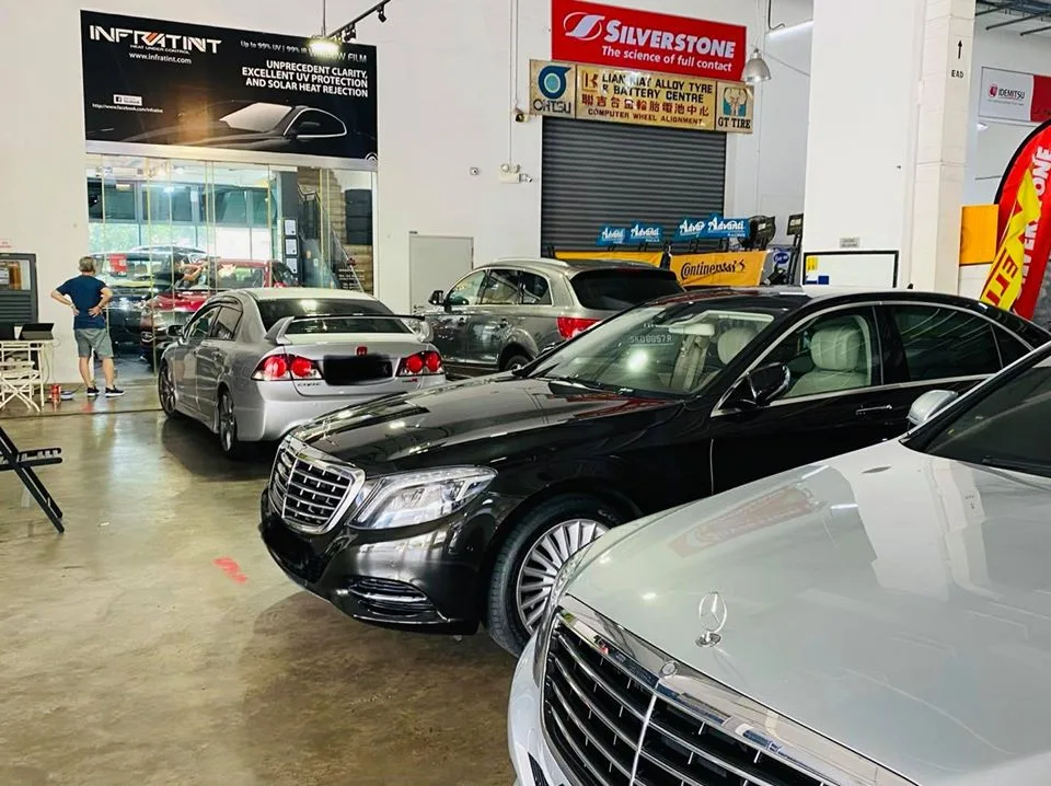 Black Mercedes-Benz S-Class sedans and a silver Honda Civic at Infratint Singapore