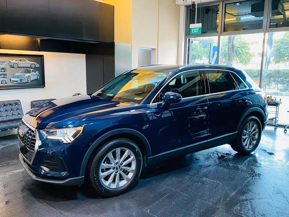Side profile of a blue Audi SUV with freshly tinted windows at Infratint Singapore