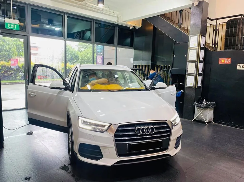White Audi Q3 with doors open in the install bay at Infratint Singapore