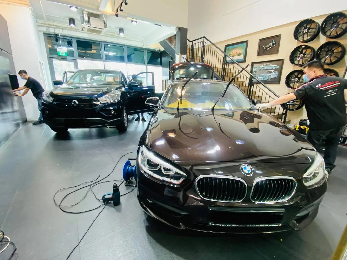 Dark brown BMW 1 Series during window film install at Infratint Singapore