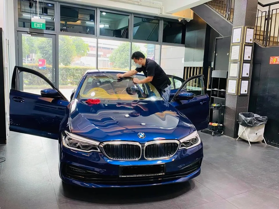 Blue BMW 5 Series getting windscreen film fitted at Infratint Singapore
