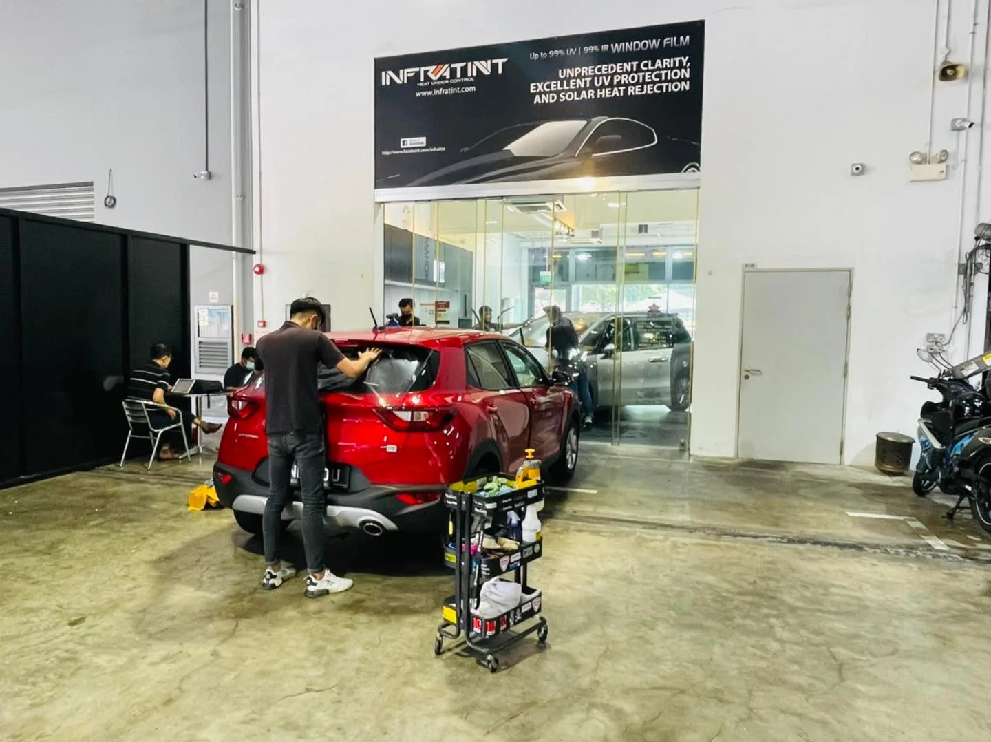 Red crossover being tinted under the Infratint banner at Infratint Singapore