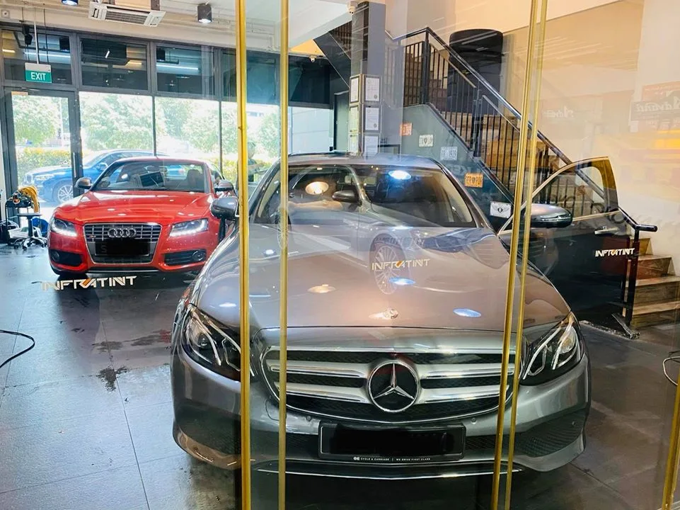 Grey Mercedes-Benz sedan and red Audi S5 at Infratint Singapore for window tinting