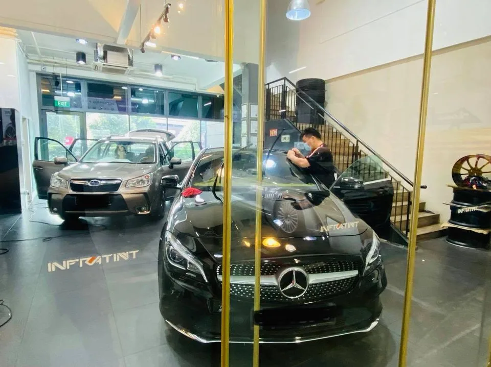 Black Mercedes-Benz CLA and bronze Subaru Forester at Infratint Singapore for window film