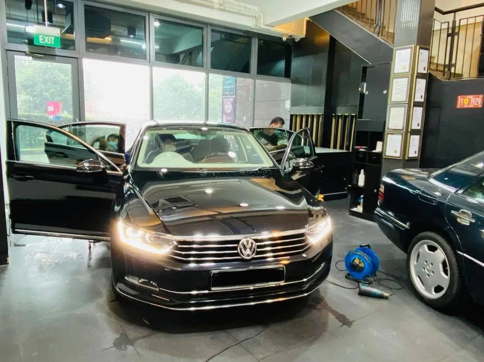 Black Volkswagen Passat sedan with doors open at Infratint Singapore for window tinting