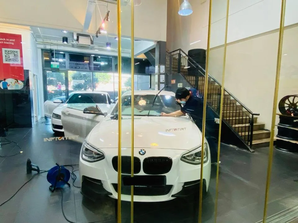 White BMW 1 Series having its windscreen tinted at Infratint Singapore