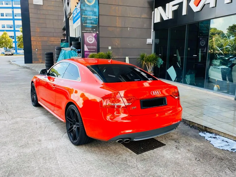 Red Audi S5 rear three-quarter outside the Infratint Singapore shopfront