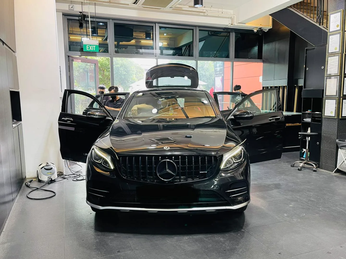 Black Mercedes-Benz SUV with doors open for window tinting at Infratint Singapore