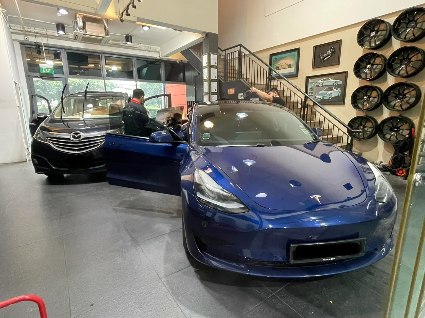 Blue Tesla Model 3 inside the Infratint Singapore showroom for window tinting