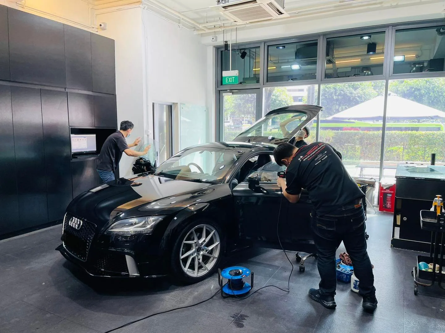 Side profile of a black Audi TT coupe during window tinting at Infratint Singapore
