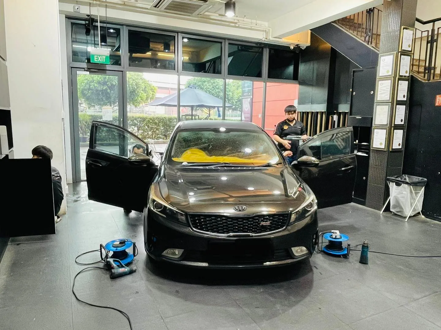 Black Kia sedan getting windscreen film at Infratint Singapore