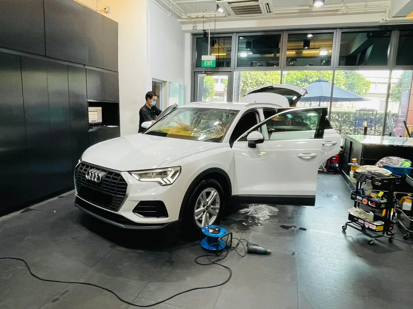 White Audi Q3 SUV with tailgate up for window film at Infratint Singapore