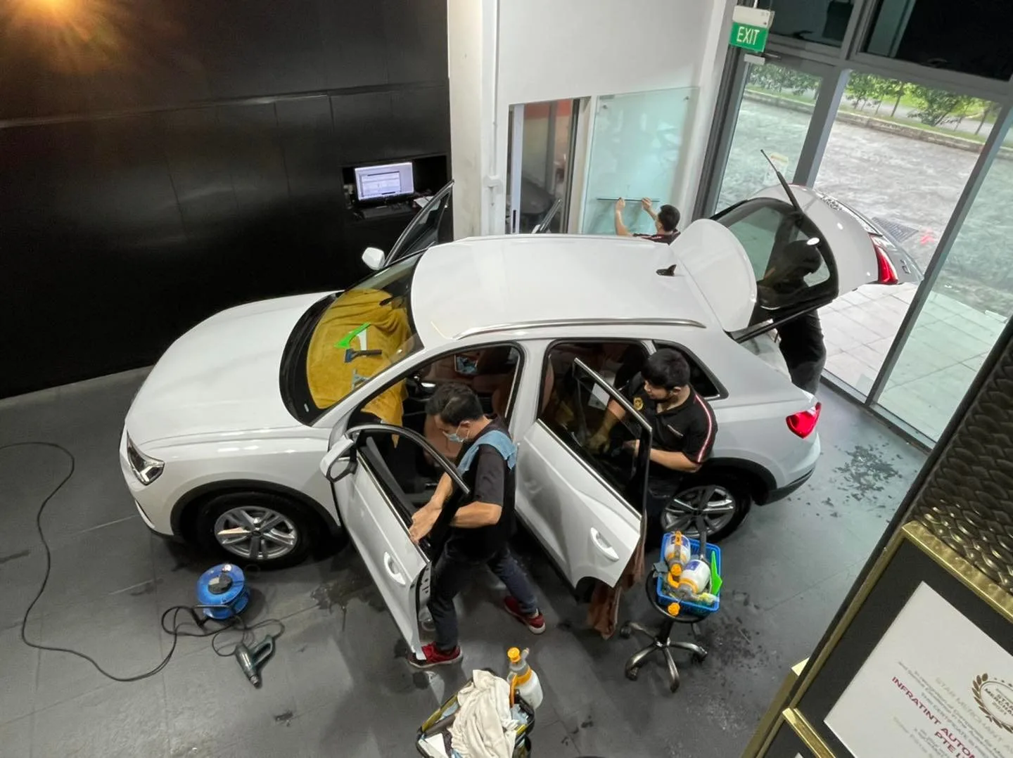 Overhead view of a white Audi Q3 being tinted by the team at Infratint Singapore