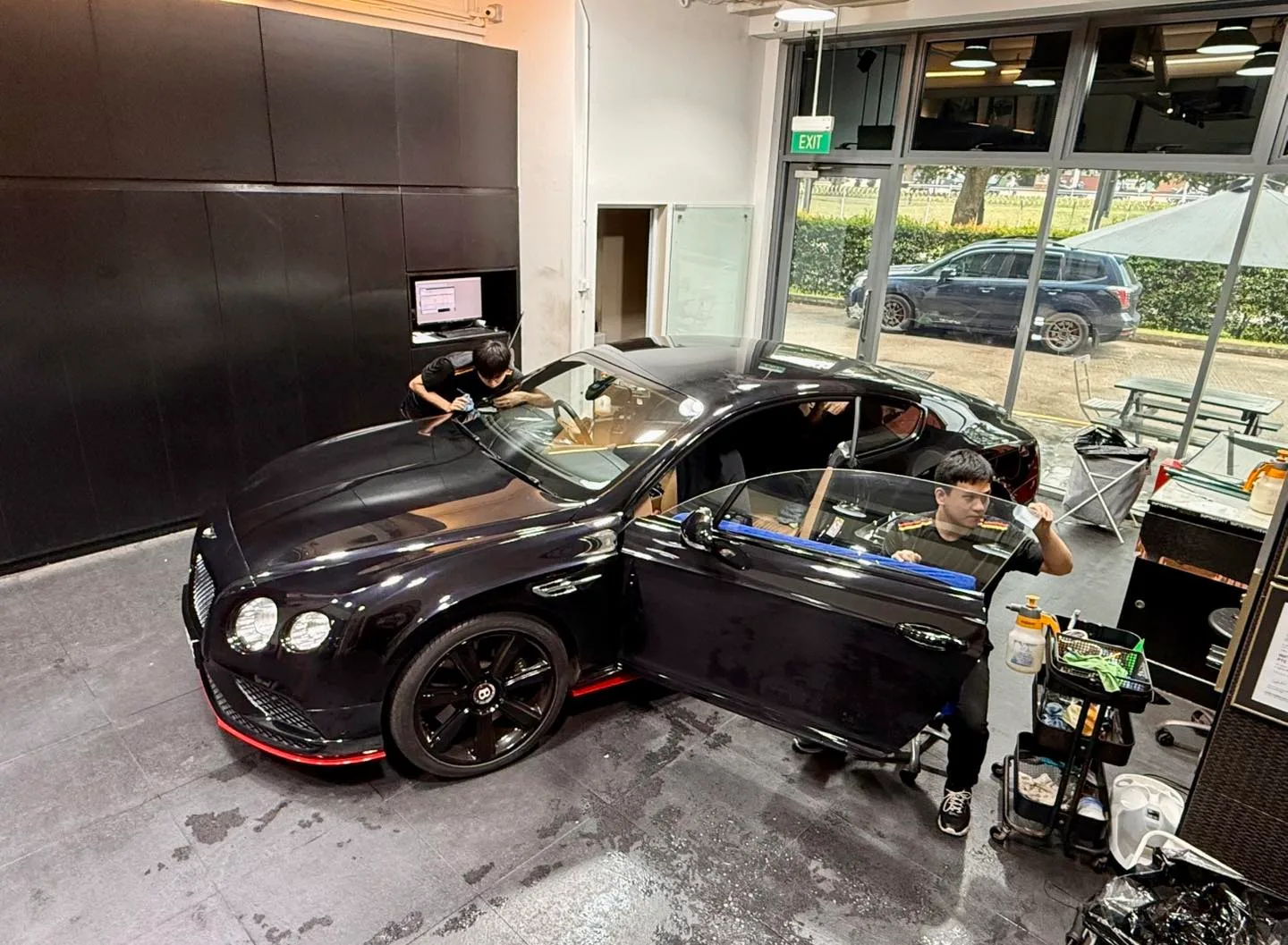 Elevated view of a black Bentley GT during window tinting at Infratint Singapore